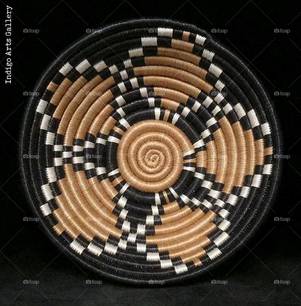 The image shows a group of hand -made dishes of wicker, decorated with colored embroideries with beautiful floral shapes, and is elegantly displayed in a warm corner that combines heritage and beauty, which gives the place an artistic spirit and attr