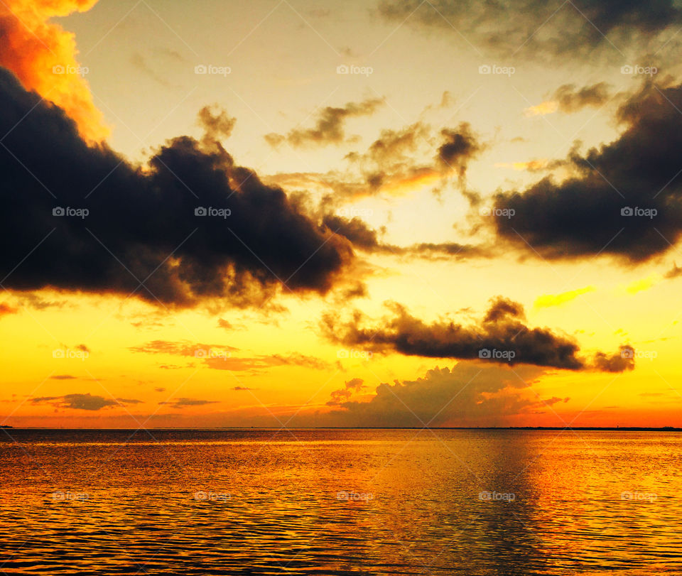 Rolling Thunder and Sunset. These powerful,puffy,dark clouds rolled in during this brilliant sunset giving it the most dramatic effect!