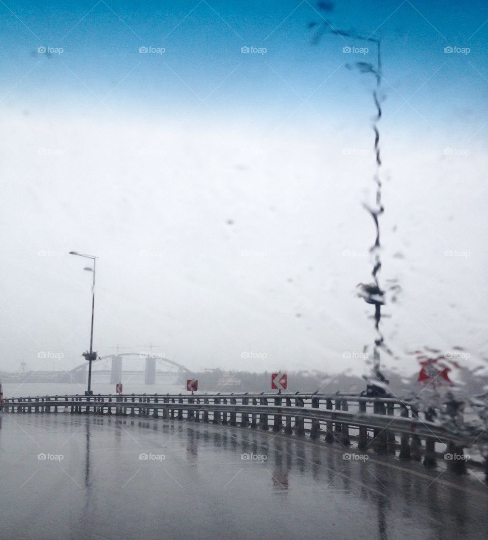 Driving in the rain on a bridge