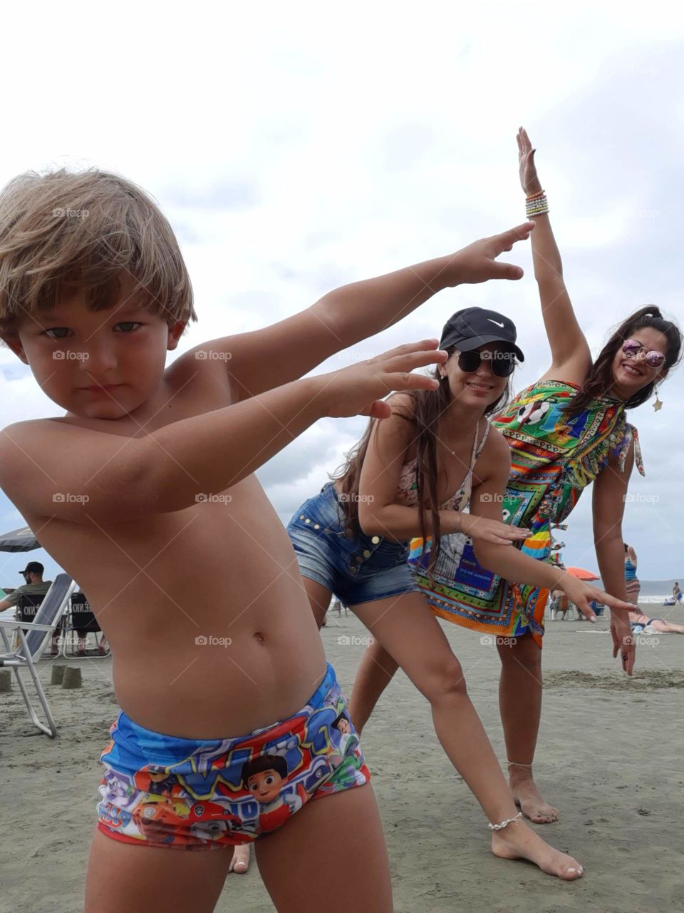family playing in a little airplane on the beach

￼