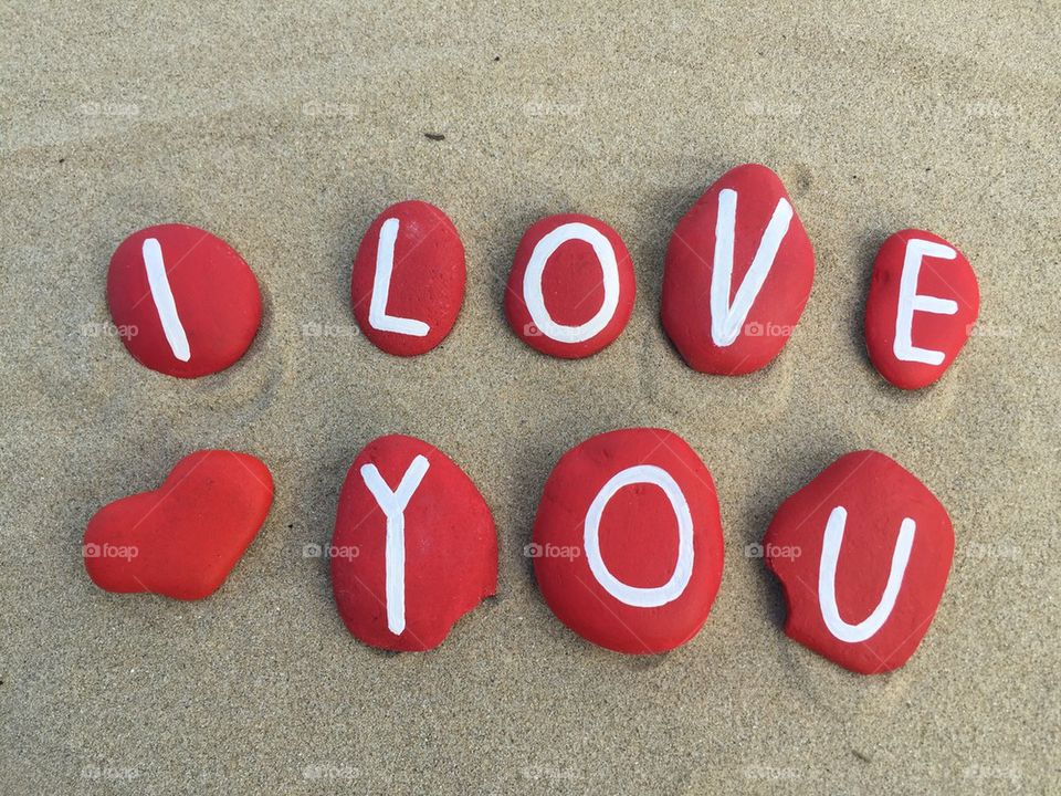 I love you on stones with red heart
