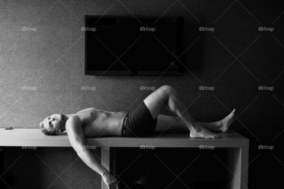 Shirtless man lying on table