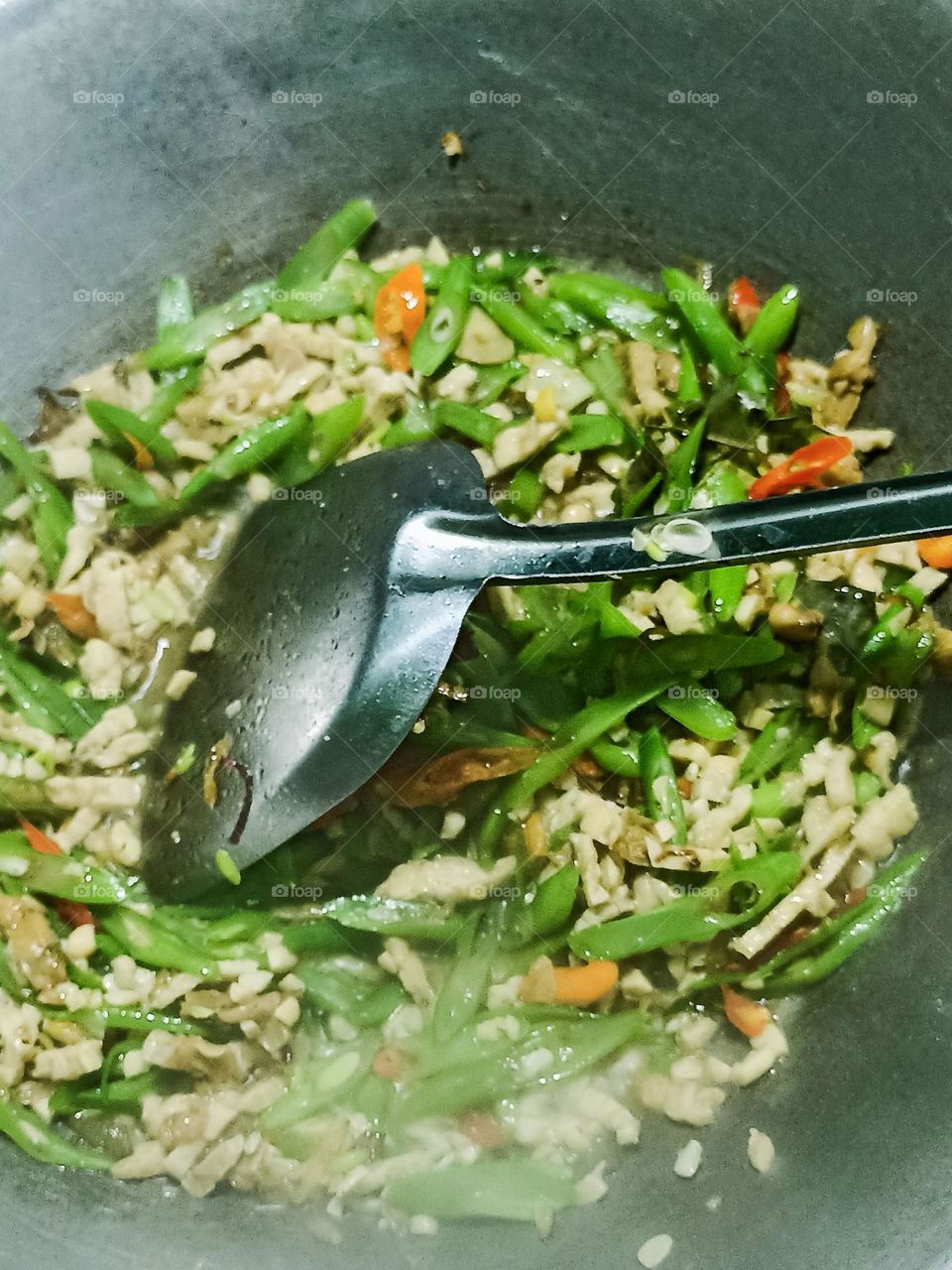 Close-up of stir-fried vegetables and minced meat cooked on a frying pan in high angle view