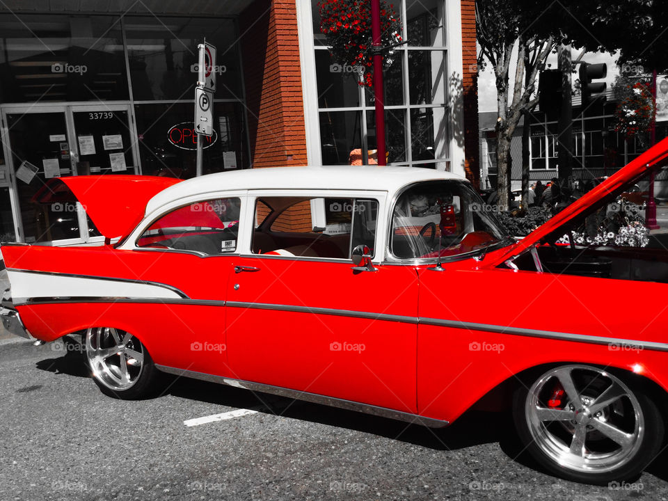 Black and White and Red Photo of an old Chevy car in the historic Downtown of my Hometown 