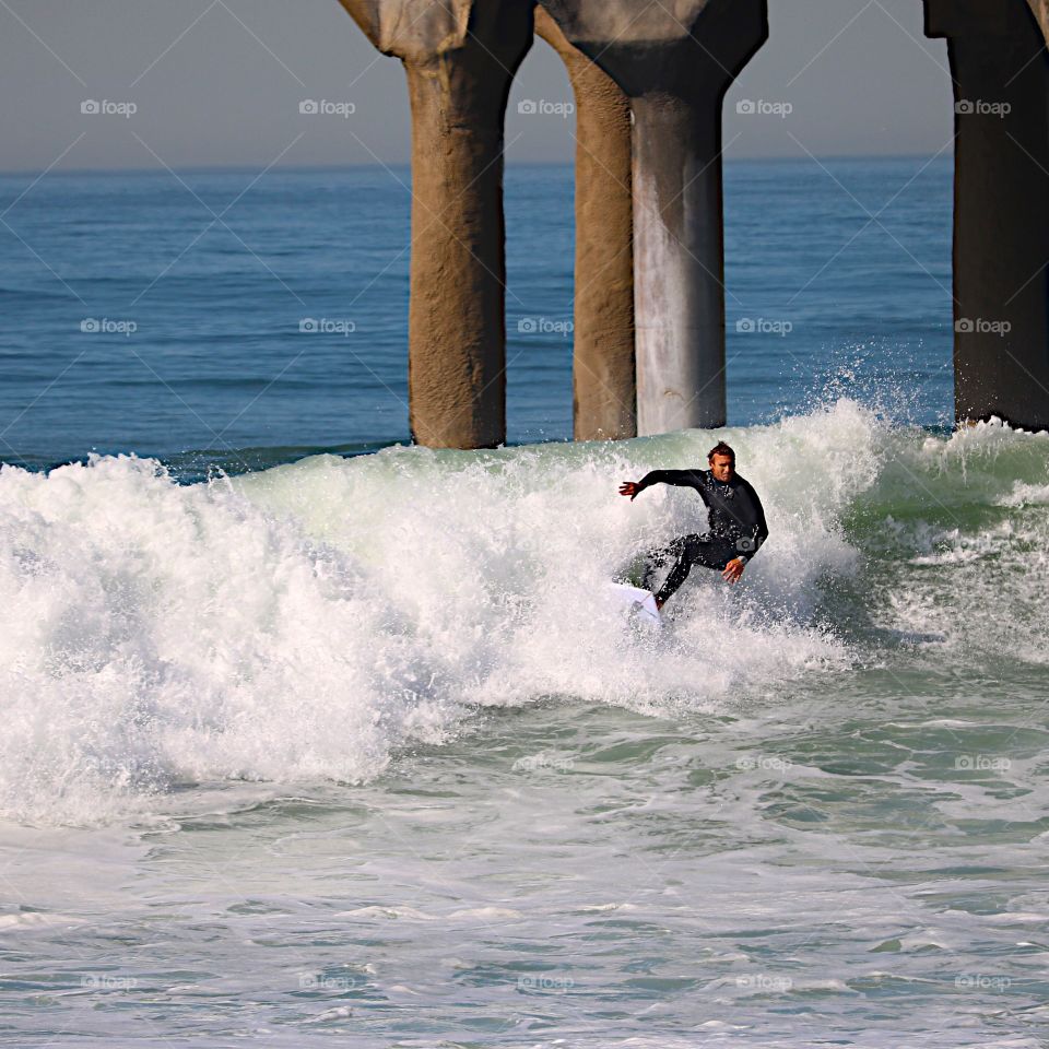 Surfer on a wave in Manhattan Beach, CA