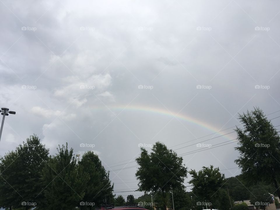 Somewhere over the rainbow fools fall in love! Gray clouds tucked behind this rainbow.