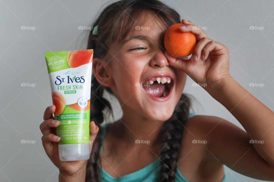 Happy girl with apricot and St.Ives body scrub