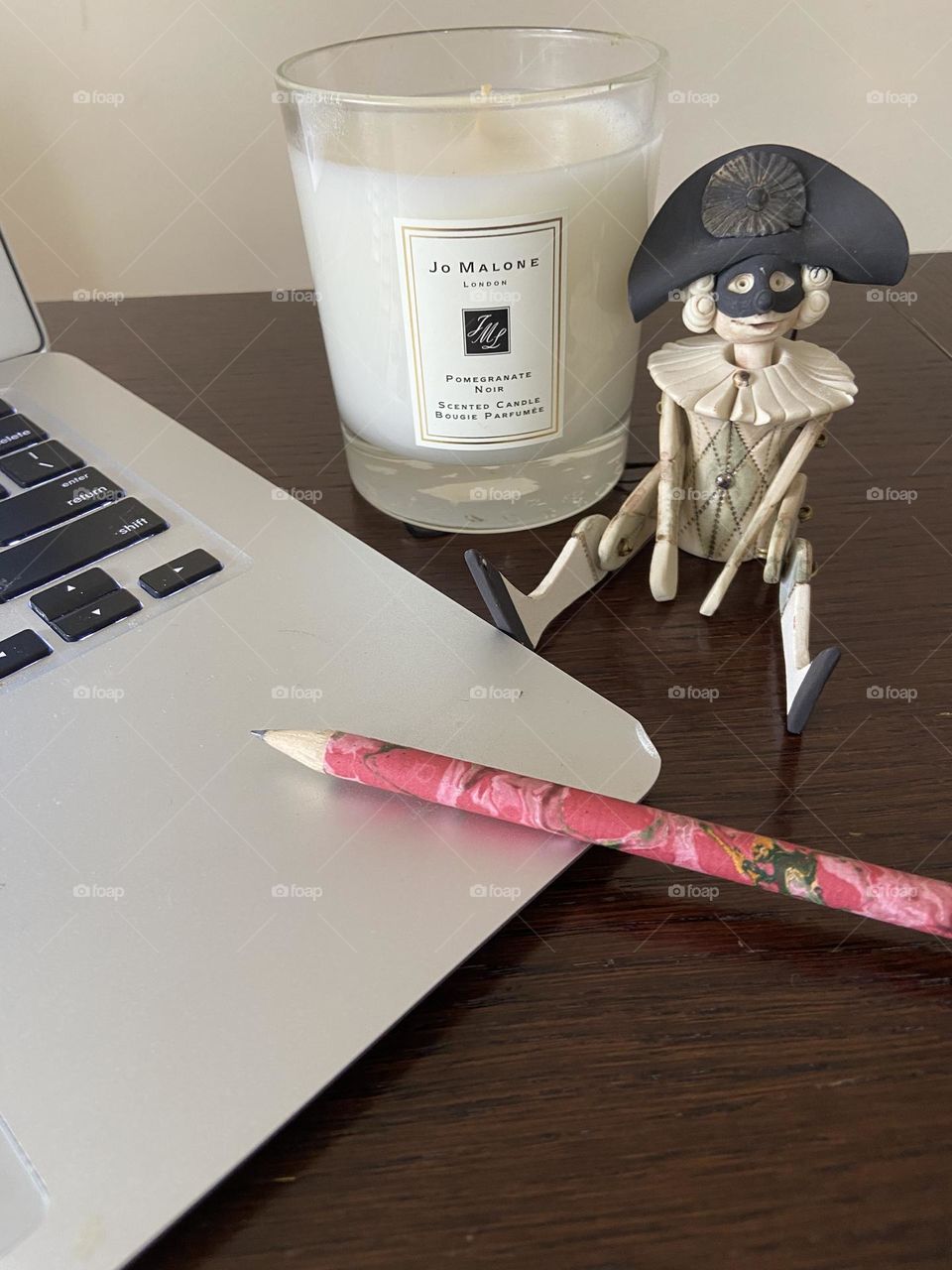 A fragrant candle, a quirky ceramic Italian jester, and a handcrafted artisan pencil to help with inspiration.