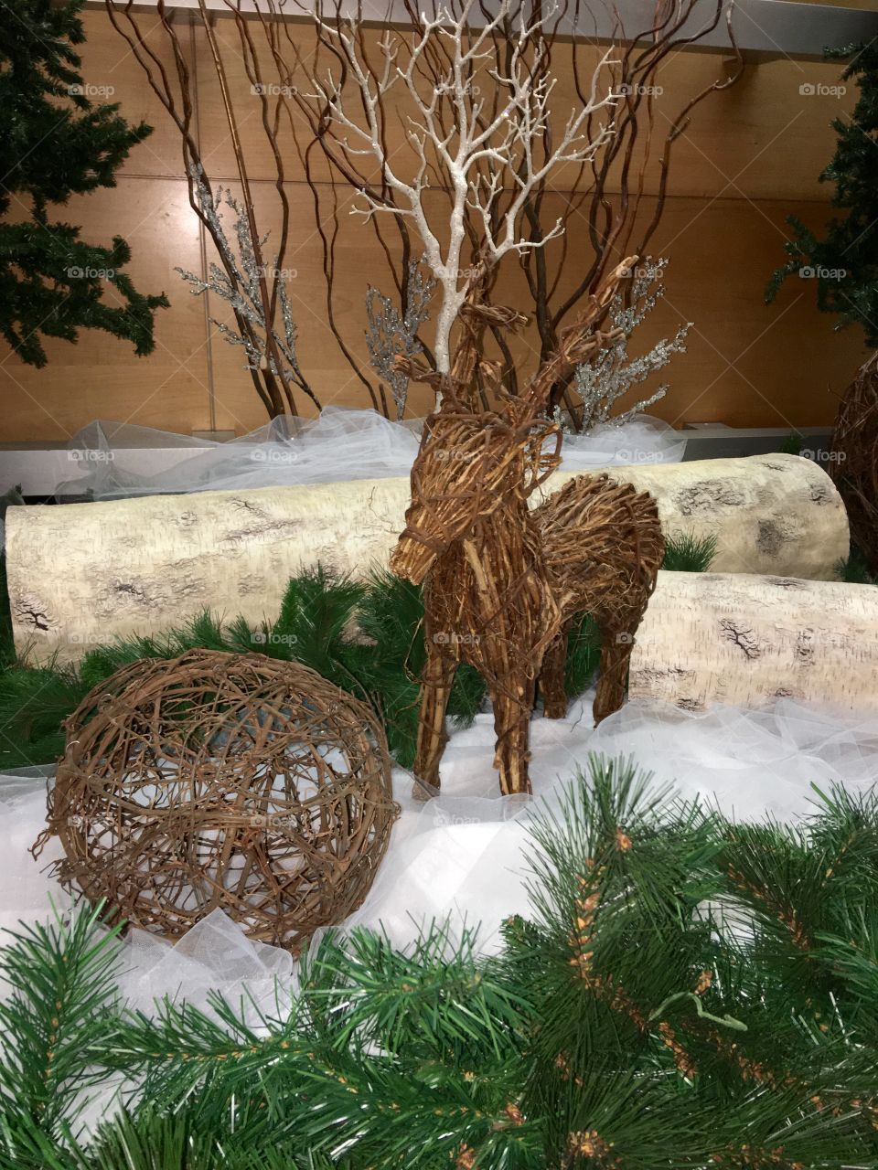 Baby Deer Holiday Decoration

Baby wicker deer alone in this display with birch white logs, round wicker ball, green foliage.
