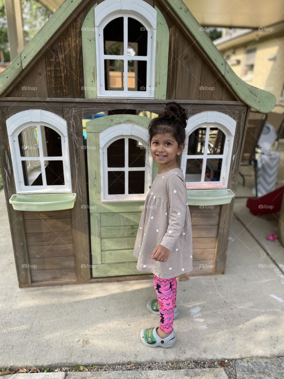 Little girl loves play house, toddler plays with playhouse 