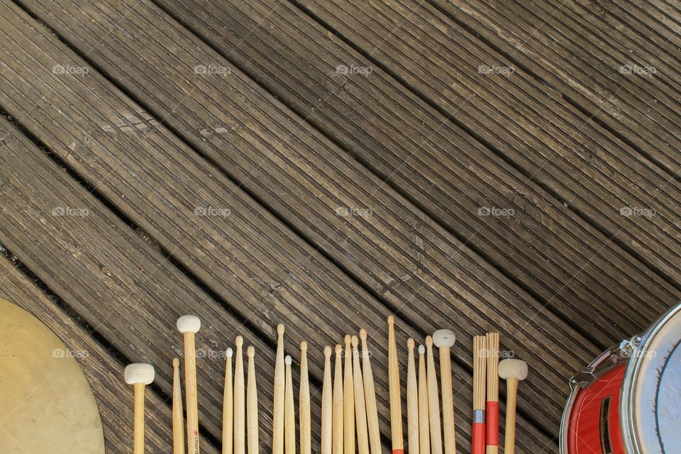 Various drumsticks on a wooden background 