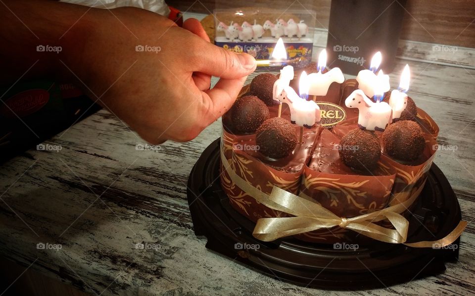 A small birthday cake. This is my son in law litting up those funny candles.