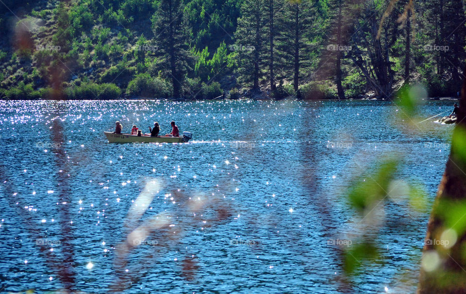 Men in boat fishing at the lake