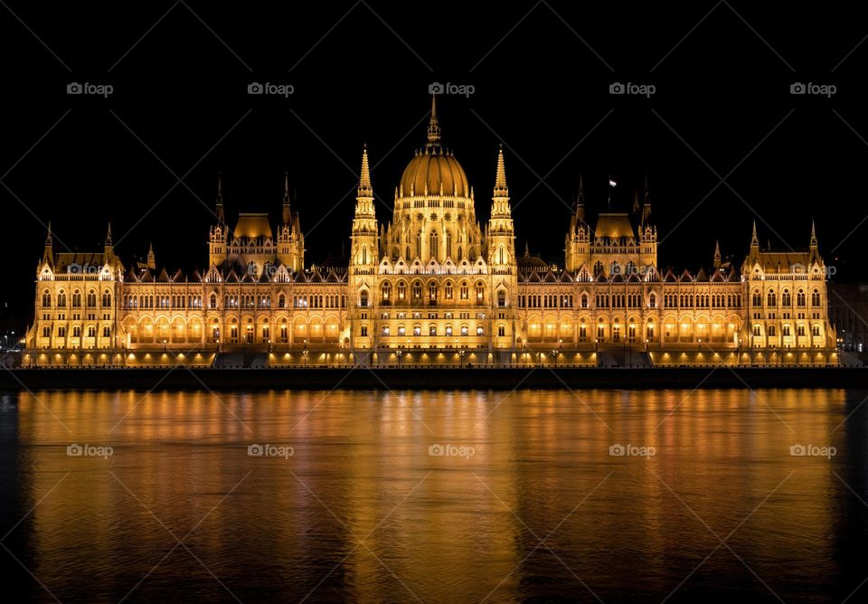 Beautiful night photo of famous Hungarian parliament building on bank of Danube river in Budapest