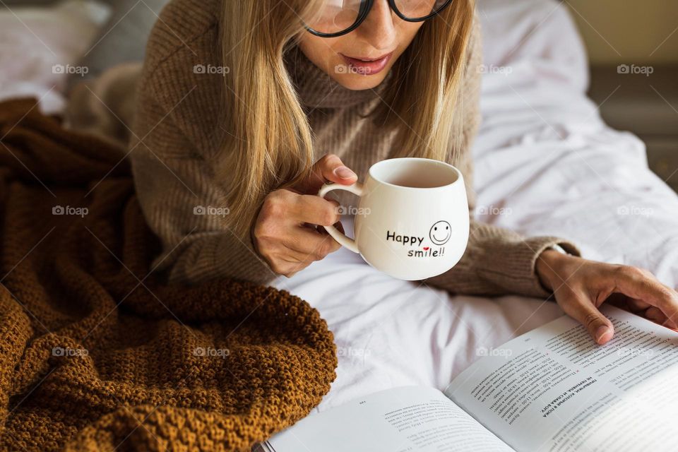 Woman drinking hot tea at home