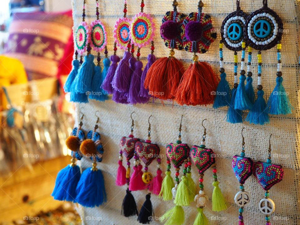 Colorful and beautiful handmade earrings hanged and ready for sale.