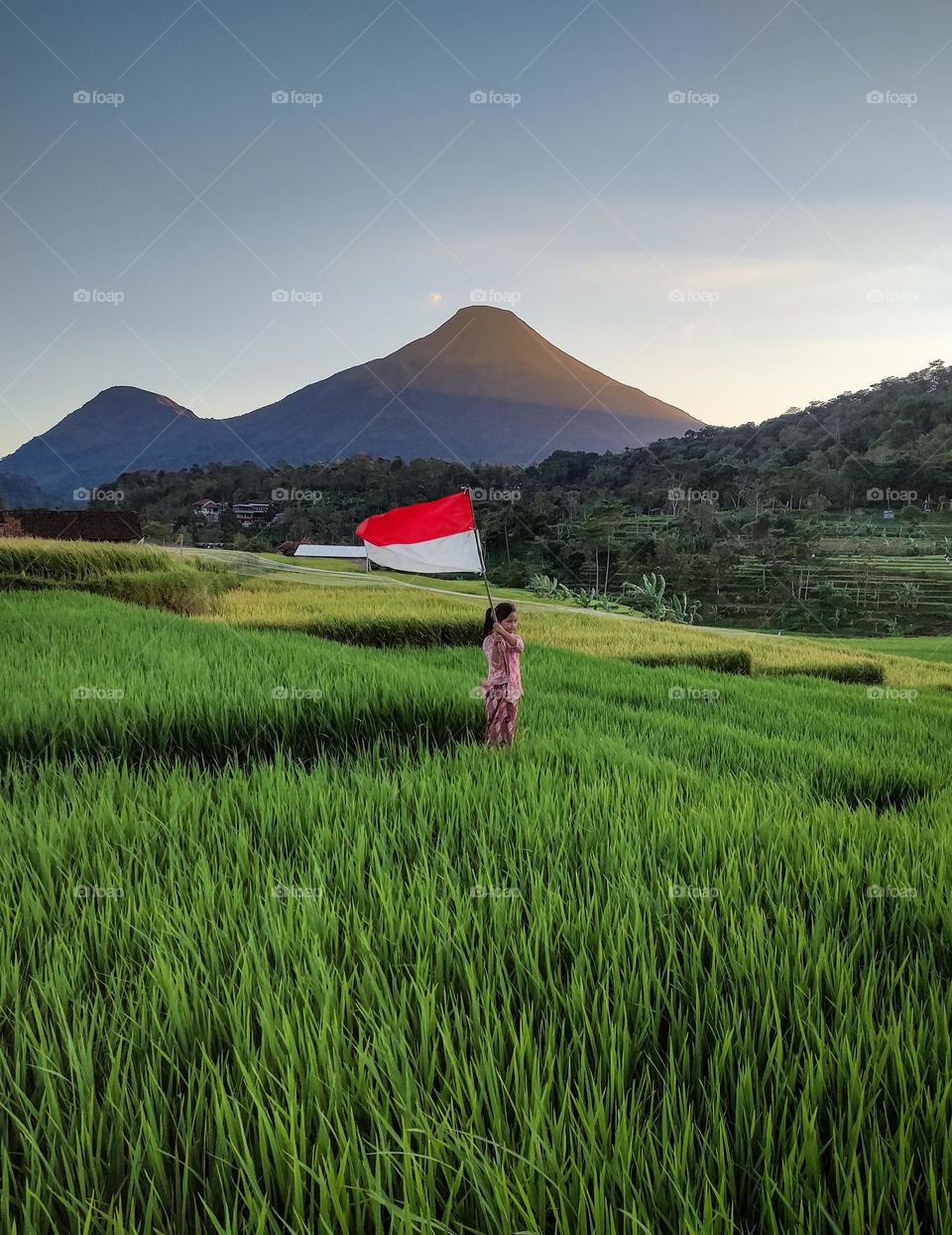 little girl waving the Indonesian flag