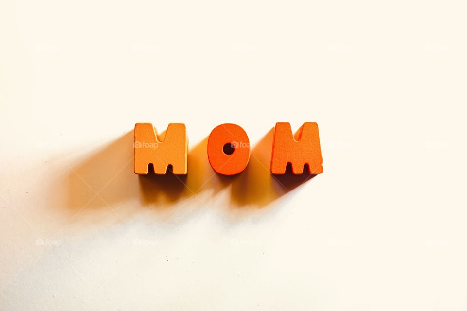 Three important wooden letters. Mother, mom 