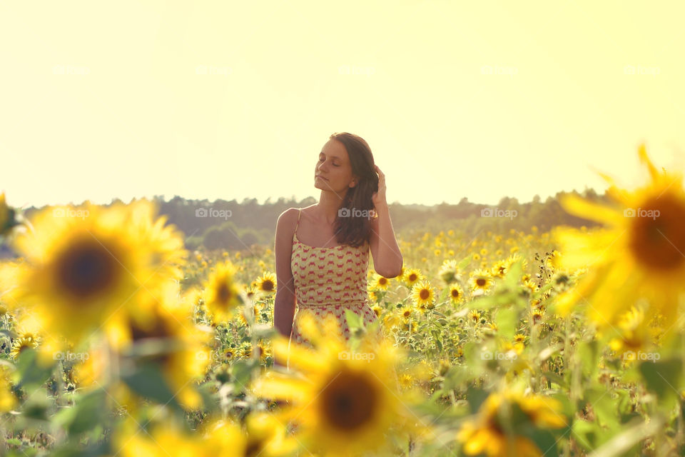 Woman in sunflower field