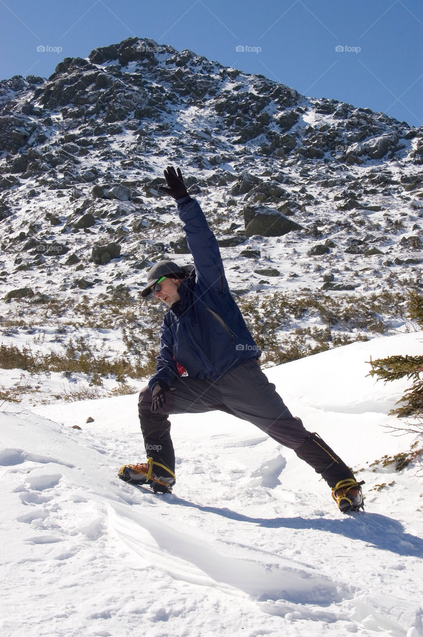 Man doing yoga on the summit of Mount Adams in the White Mountains of