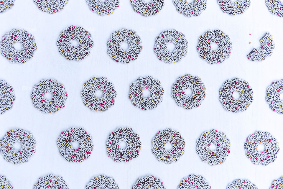 Flat lay of rows of round sprinkled cookies