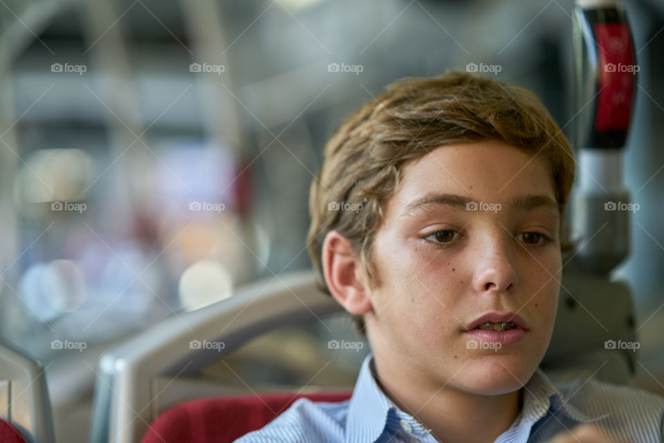 Teenage boy sitting on chair