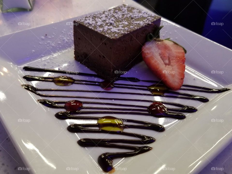 Chocolate flourless mousse cake with strawberries and a festive holiday inspired plate design sinfully delicious 