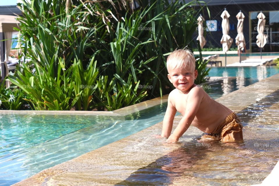 Blond boy playing with the water 