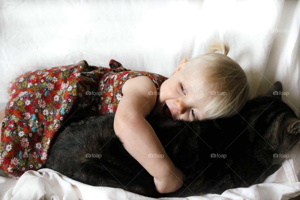 happy toddler and her kitty