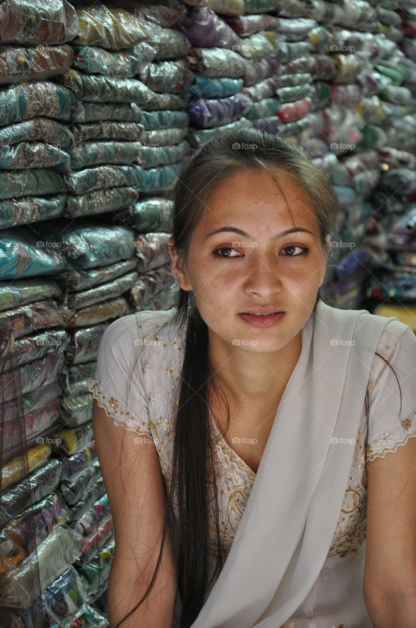 Asian woman sitting in saree shop