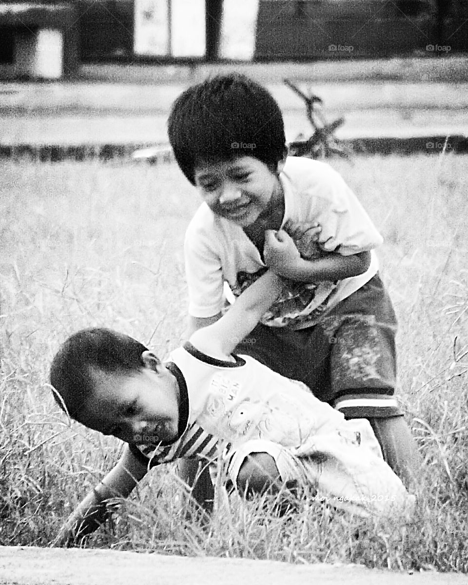 Two brothers playing in field