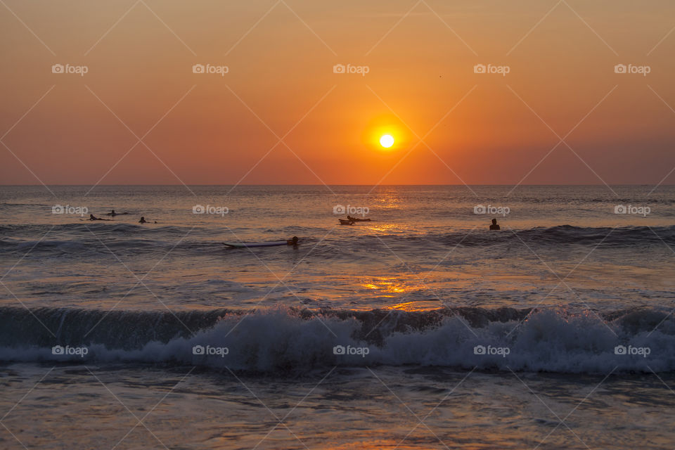 Silhouettes of surfers