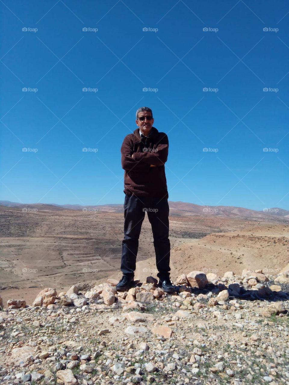 Im standing on a rocks embraced blue sky at chichaoua city in Morocco.