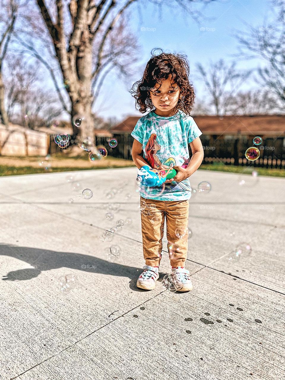 Toddler girl outside blowing bubbles, unusually warm winter weather, go outside, kids and bubbles, fun activities for children, toddler girl occupies herself with bubble blower, bubbles and toddlers, toddler playing outside, blowing bubbles with mom