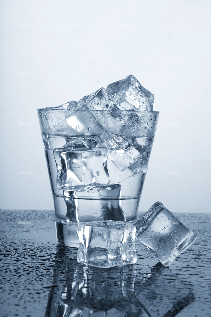 Chilled water glass with ice cubes