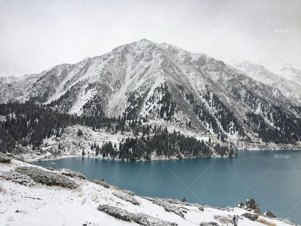 I forgot cold for a while... Snow mountain , Pine forest,  Water stream Beautiful blue lake at big Almaty lake in Kazakhstan