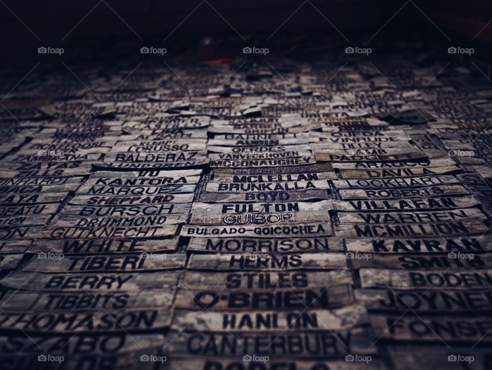 Mural of military members leaving name tags from their uniform at a high traffic stop point. 