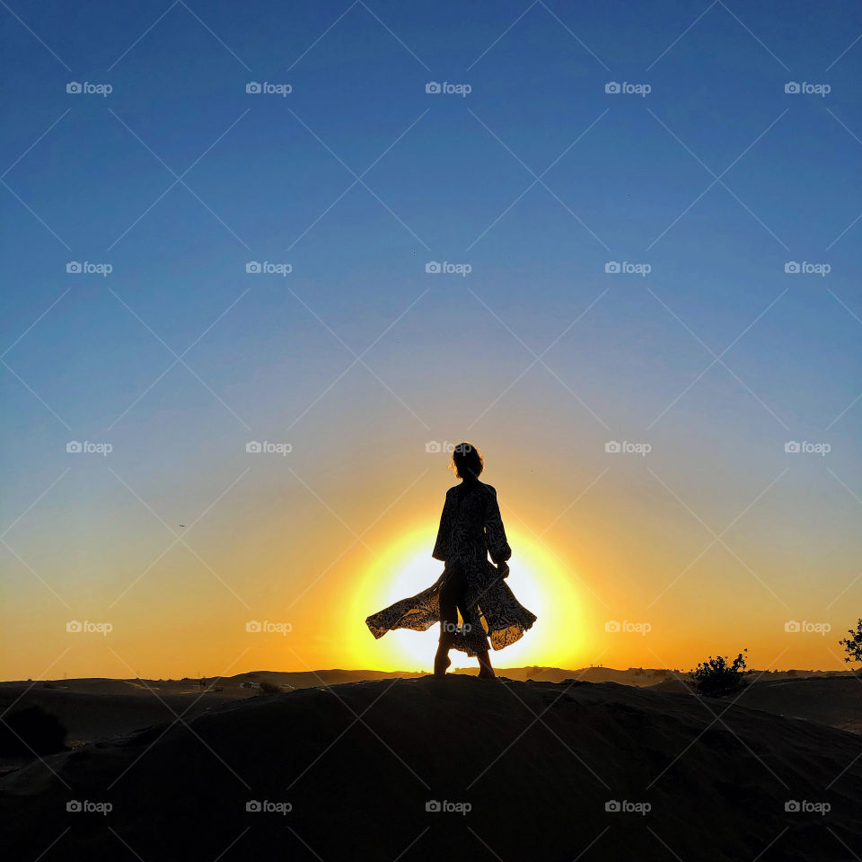 girl in the rays of the setting sun.  desert
