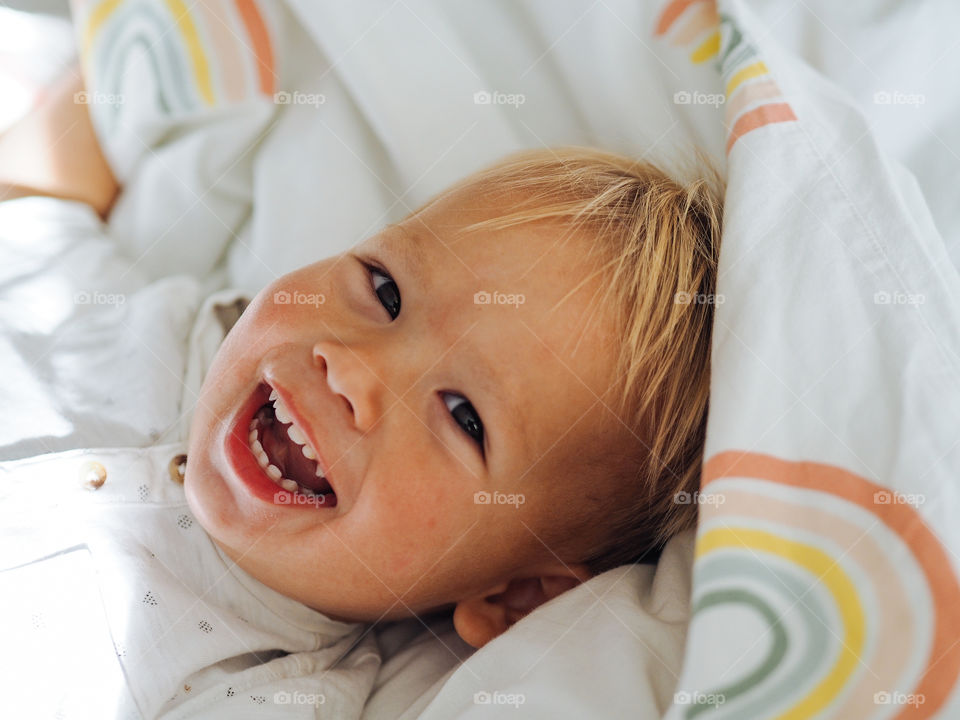 Pretty blond toddler boy smiling 