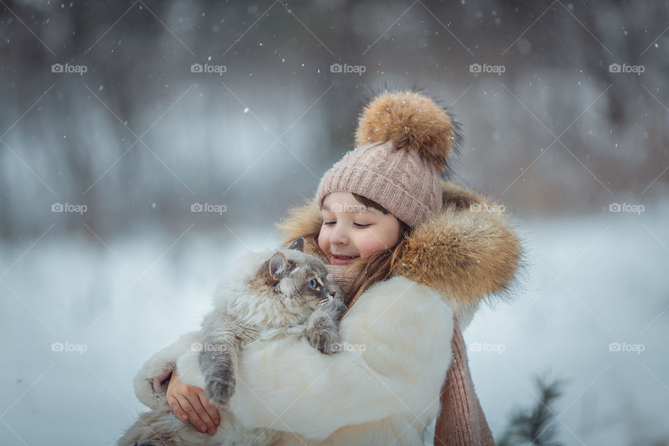 Little girl portrait with cat, winter outdoor 