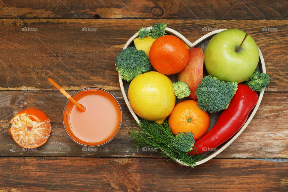 Health food concept. Fruits and vegeta les heart shape wooden  box. Vitamine juice glasses with straw. Diet ans fitness.