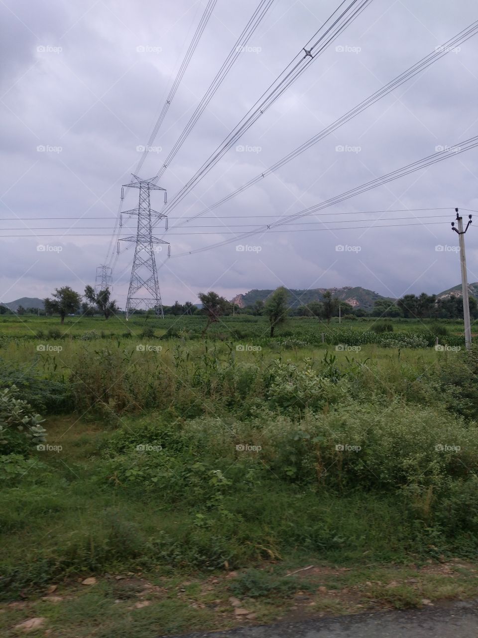 Scenic view of electricity pylon in field