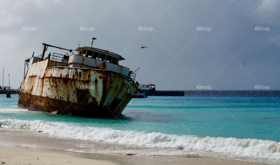 Stranded old ship on a beautiful, tranquil beach 