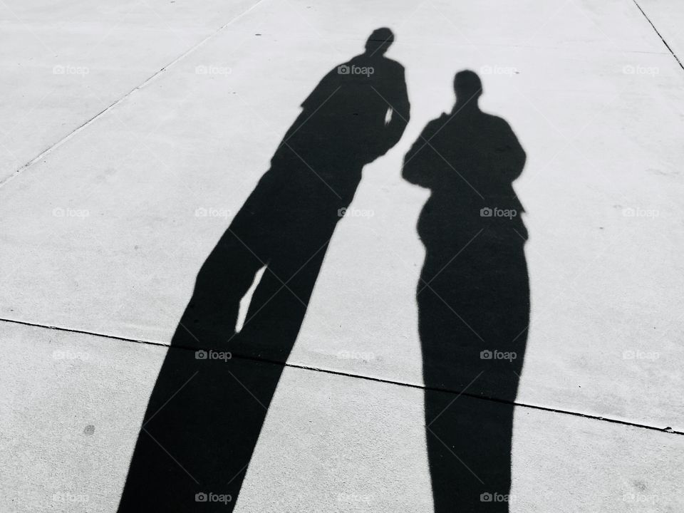 Black and white silhouette or shadow of  a couple walking 
