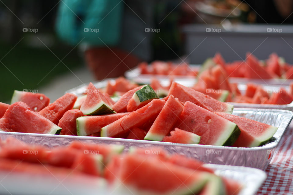 Rows of fresh watermelon at a BBQ 