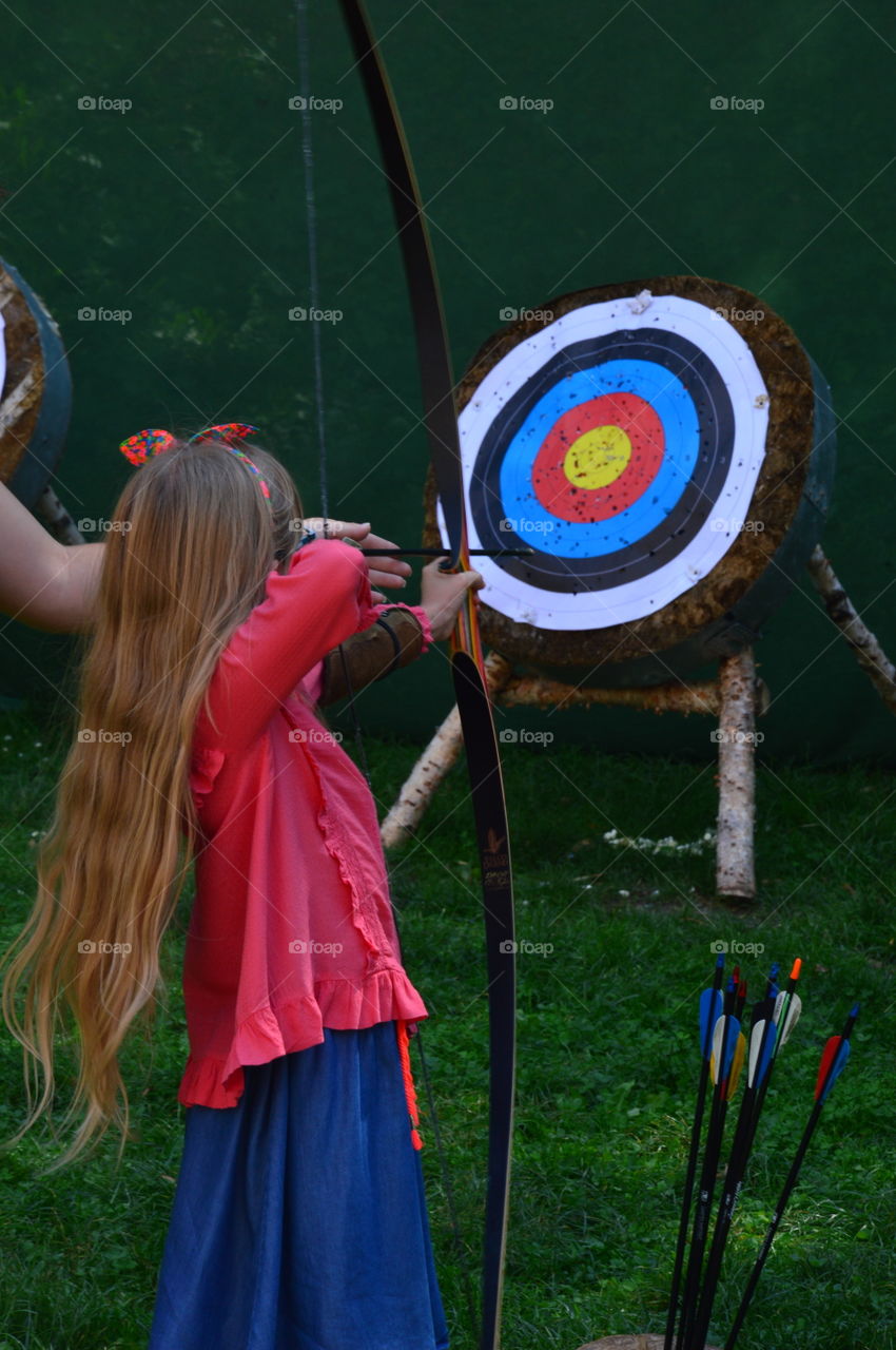 little girl playing archery