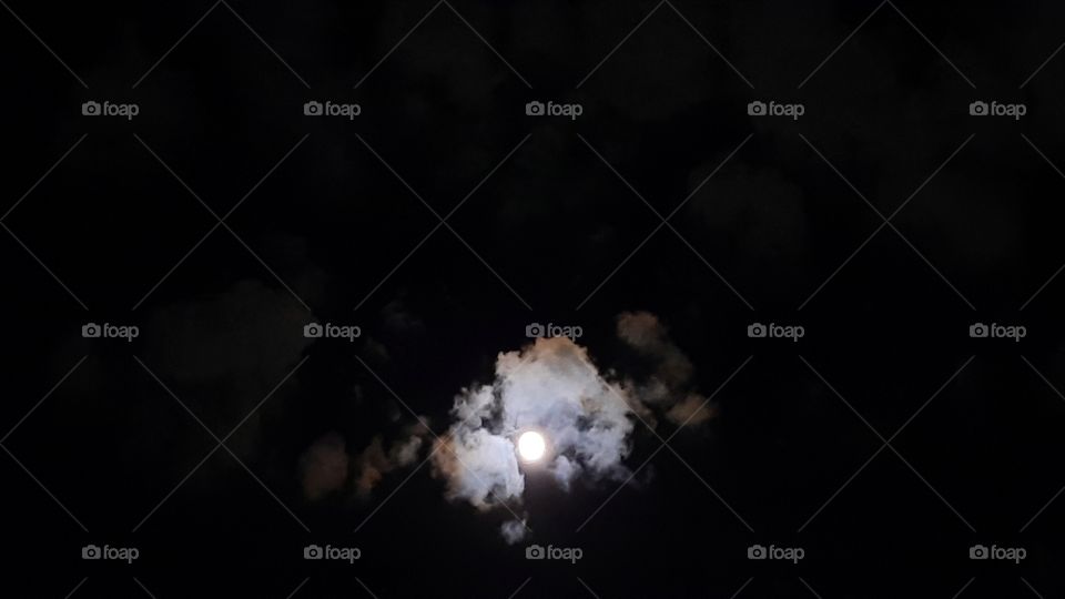 Moon between clouds,moon,clouds,sky,night,evening,nature,landscape,shining,black,colorful