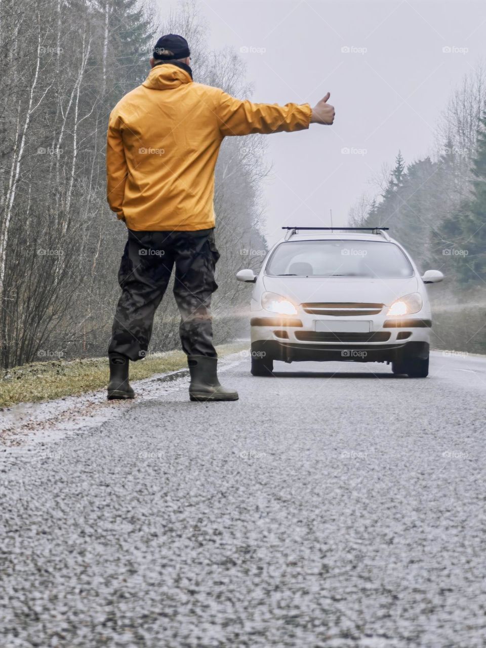 A man stops a car on the road