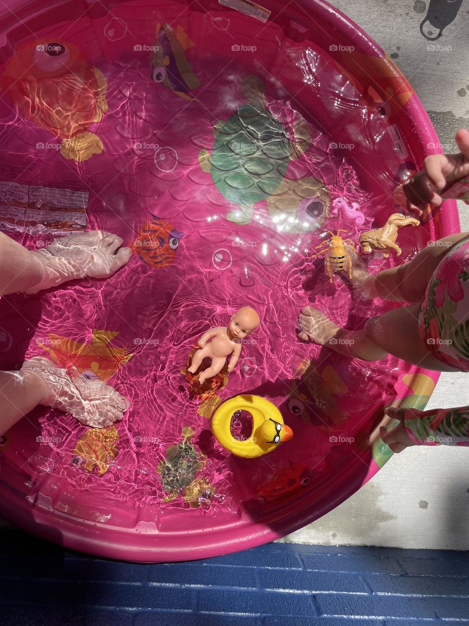 Feet in the pool, hot weather cool off, heat wave outside, water in the pool, in the kiddie pool with a toddler, mommy hangs out with toddler 