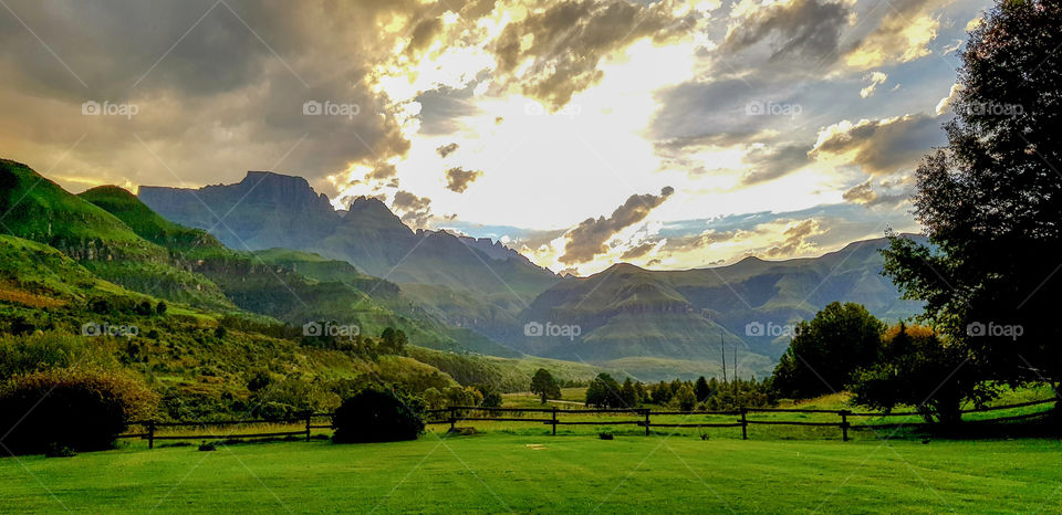 The sun peeking through the storm clouds over the Drakensberg Mountains in KwaZulu-Natal, South Africa
